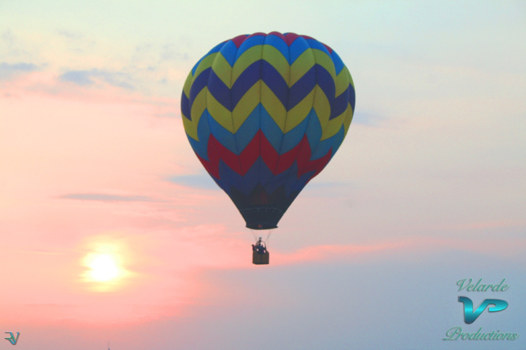 Colorful hot-air balloon floating in a pastel sunset sky