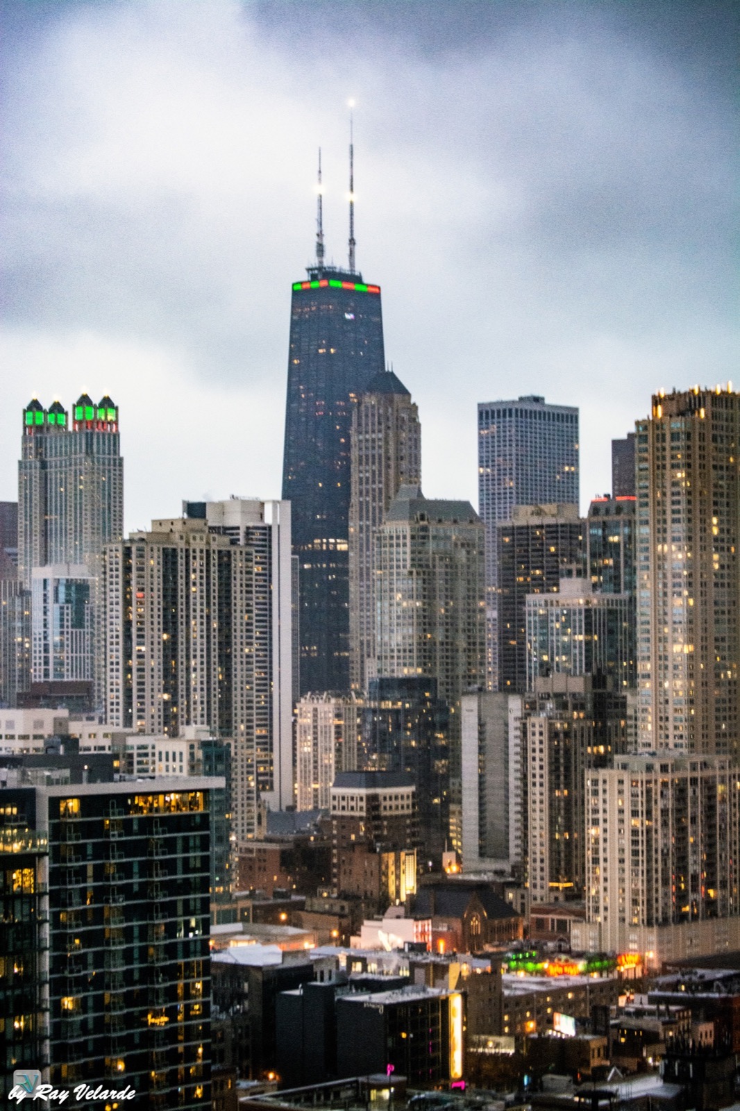Chicago skyline glowing beneath a soft gray-blue dusk sky