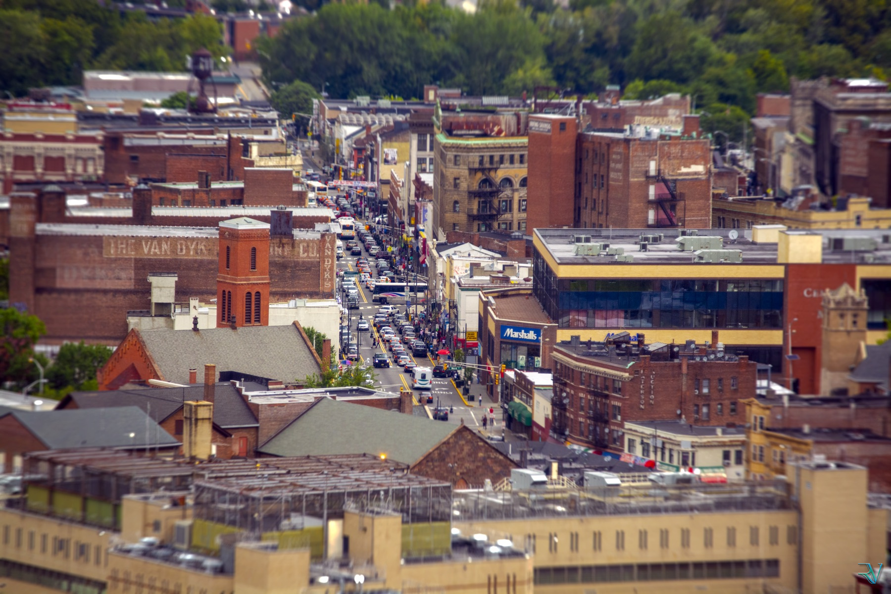 Tilt-shift view of a busy street passing through an old city neighborhood