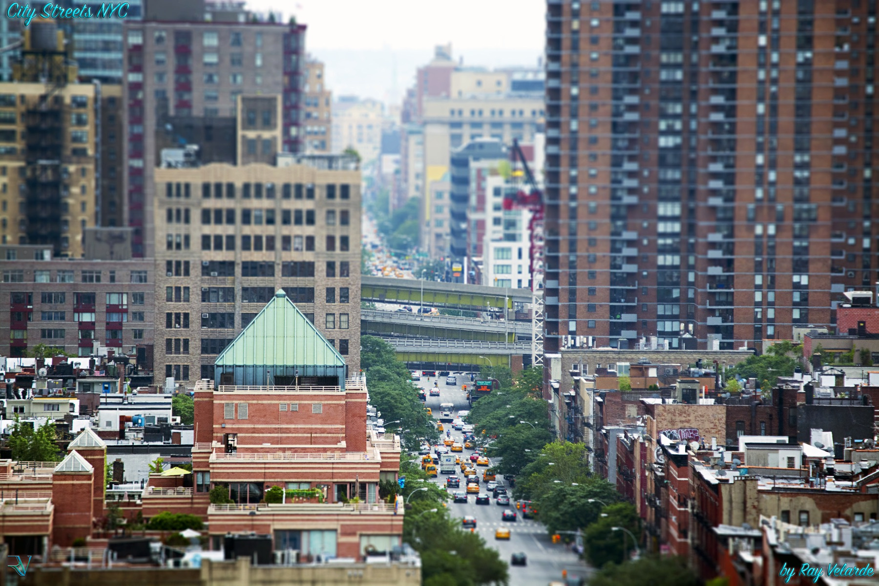 Long telephoto view of a busy New York City street between buildings