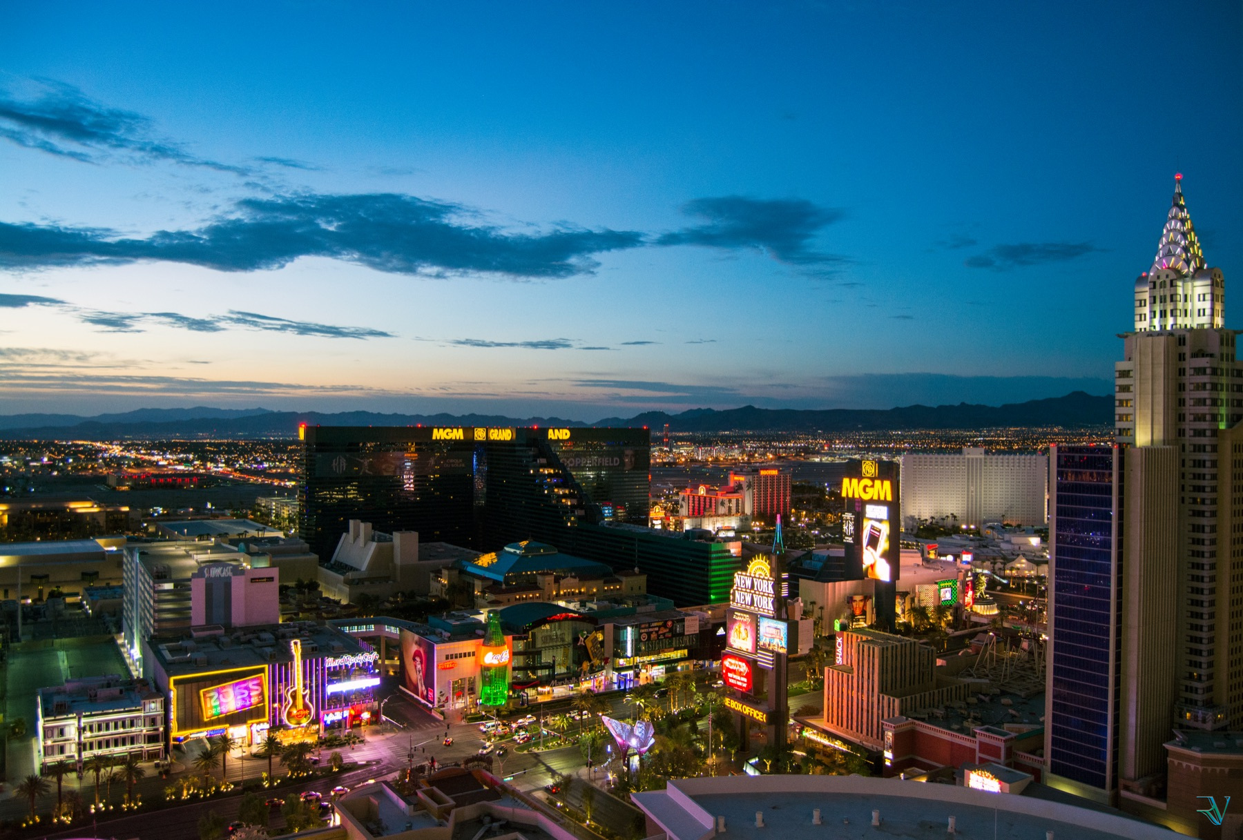 Las Vegas Strip glowing with neon beneath a deep blue evening sky