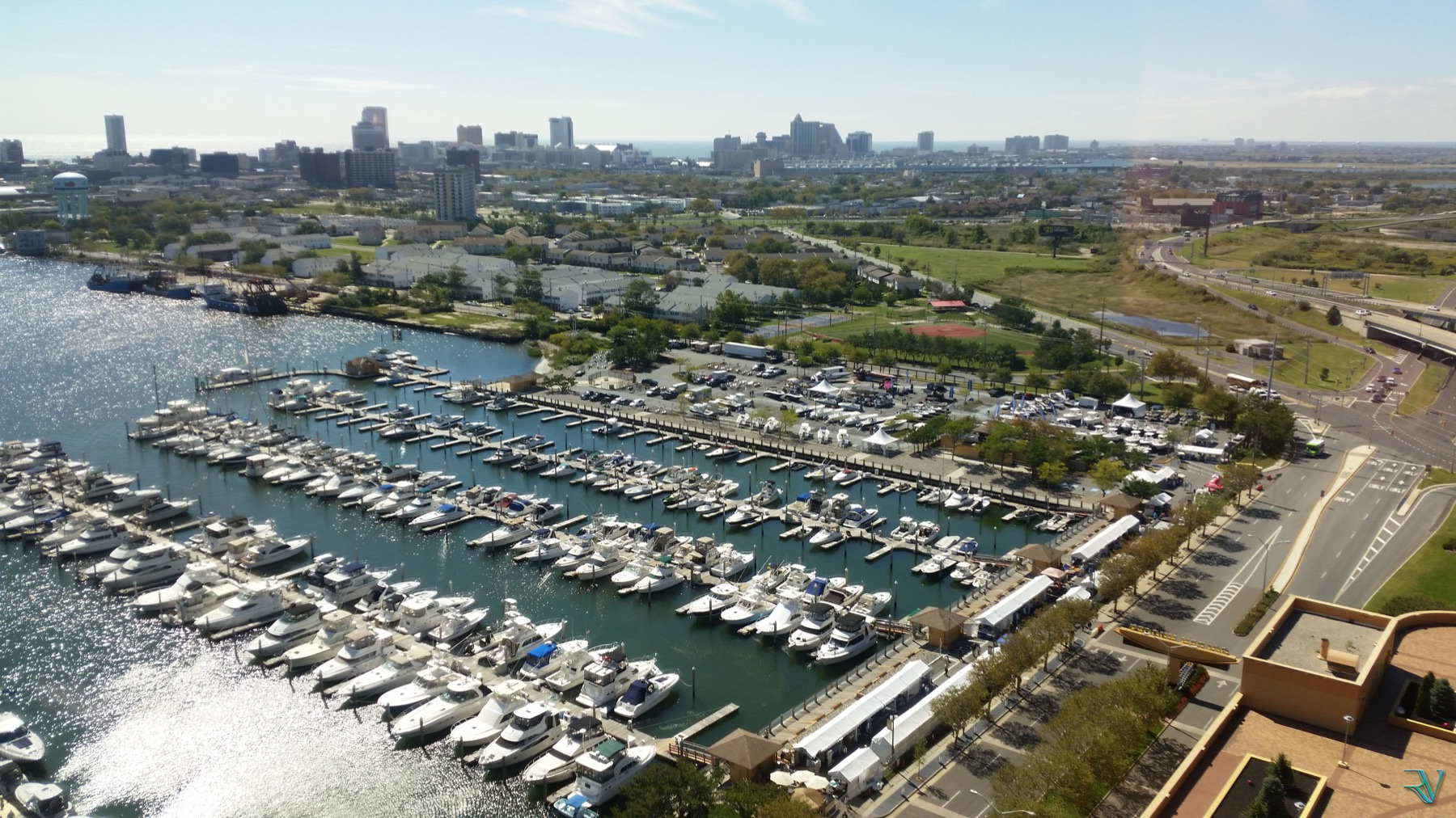 Sunlit marina filled with boats viewed from high above
