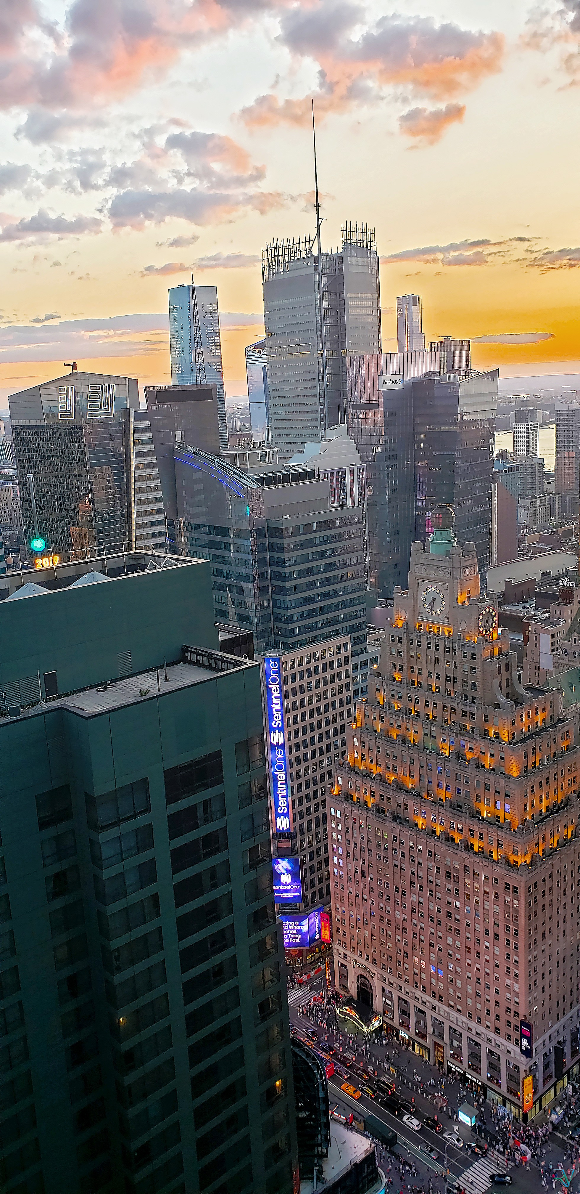 Vertical view over Midtown Manhattan beneath a vivid sunset sky
